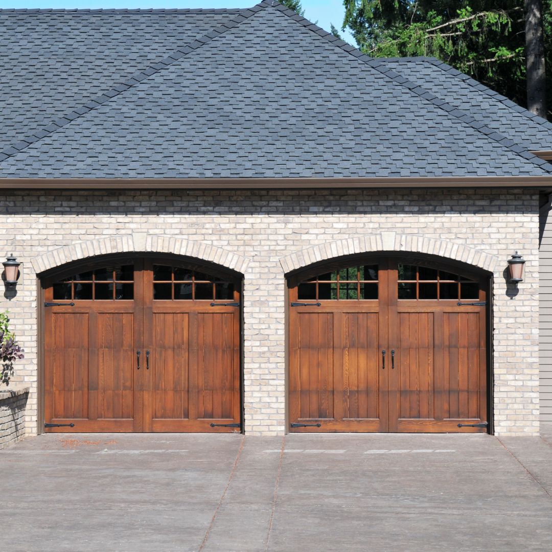 Home with two wood garage doors